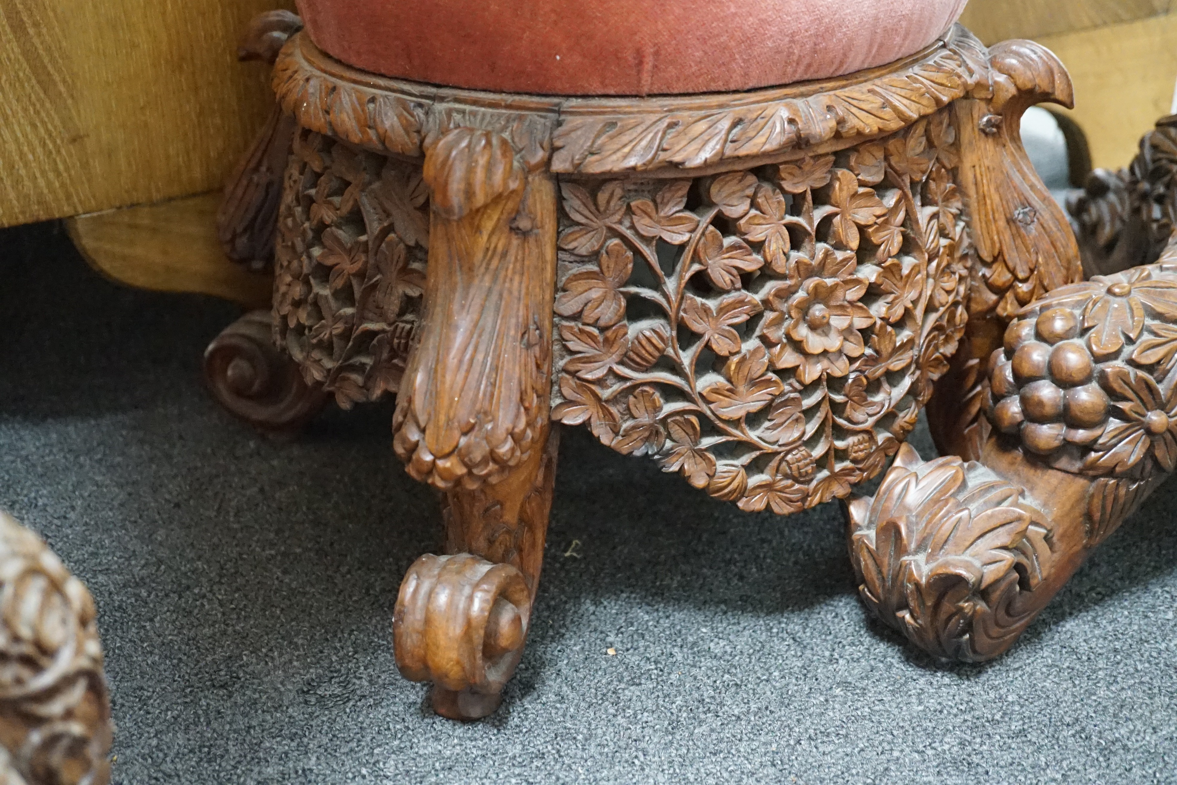 A Burmese carved hardwood circular occasional or centre table, diameter 57cm height 74cm, together with a similar side chair and foot stool